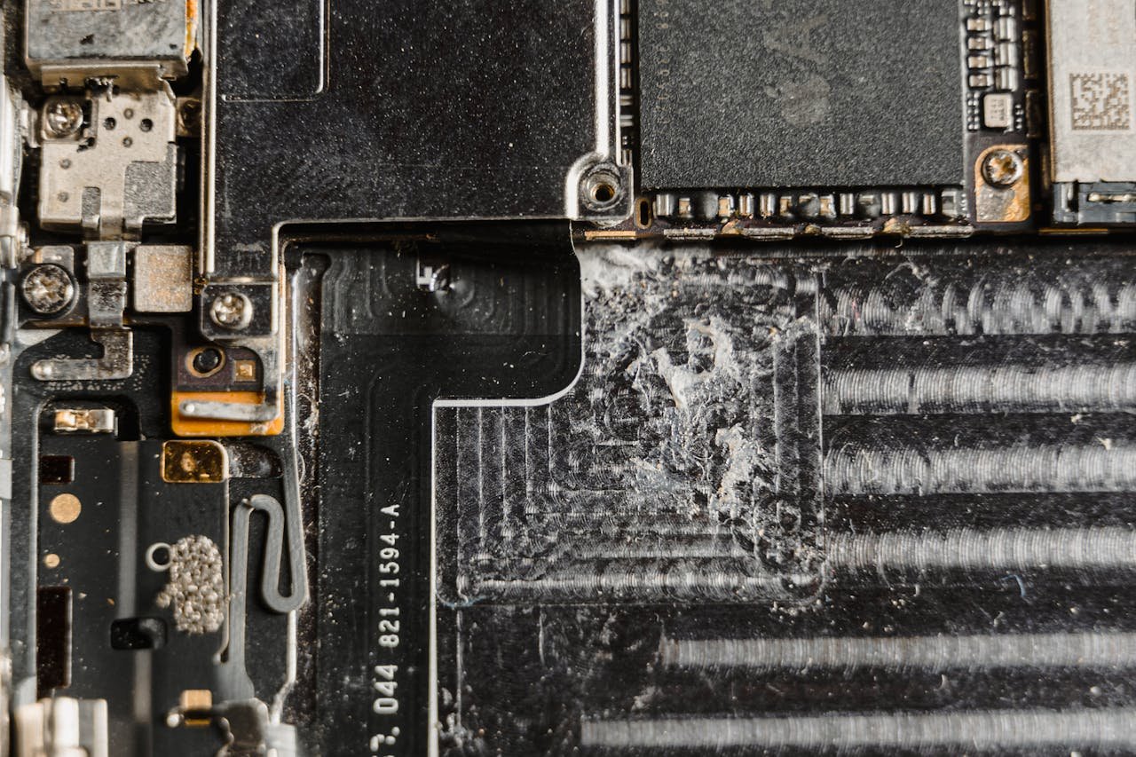 Detailed close-up of a dusty mobile phone circuit board showcasing various electronic components.